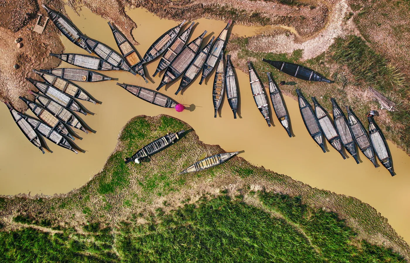 Aerial view of boats moored on a river bend