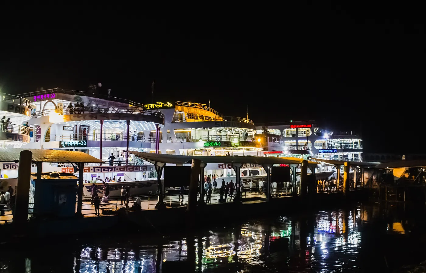 Launches lit up at the river terminal at night